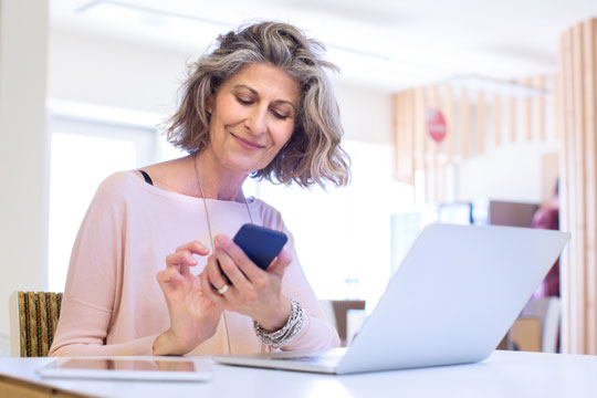 woman with phone and computer